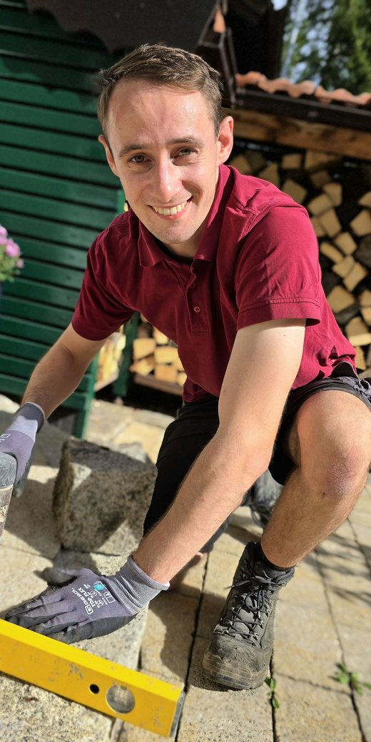 Daniel Premm beim Verlegen von Granit-Pflastersteinen